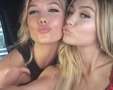 Two women posing playfully for a selfie, both making a kissing face toward the camera.