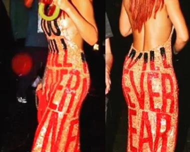 "Rihanna wearing a sequin backless dress with red bold text "YOU WILL NEVER OWN ME" from Discount Universe."