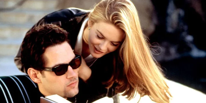 Alicia Silverstone's Cher leans over Paul Rudd's Josh who is wearing sunglasses in a scene from "Clueless."