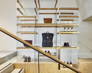 Wooden and glass shelves displaying fashion accessories and products at the APC Sydney store.