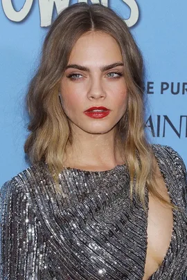 Cara Delevingne in a silver textured dress with red lipstick, wavy hair, at "Paper Towns" premiere.