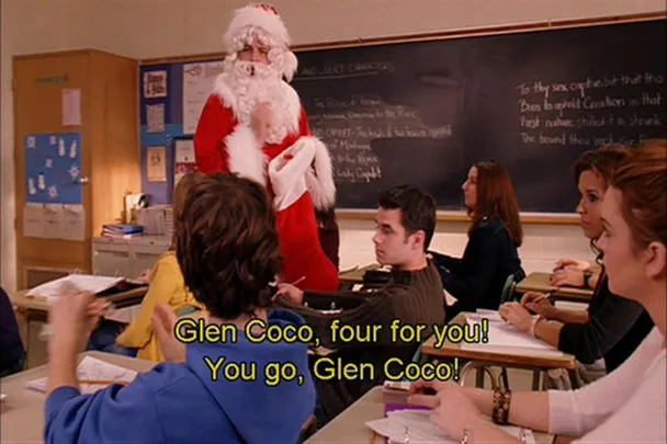 A classroom scene from "Mean Girls" with a person in a Santa costume handing out candy canes, captioned "Glen Coco, four for you!"