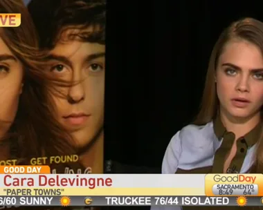 Cara Delevingne on Good Day Sacramento discussing "Paper Towns" with a movie poster in the background.