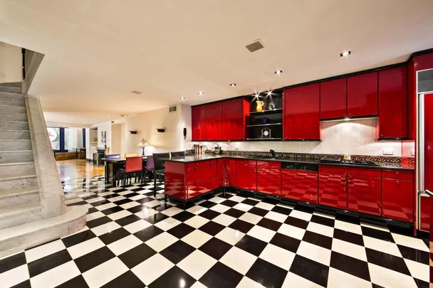 Red kitchen with checkered floor and sleek cabinets in Marilyn Monroe's Upper East Side apartment.