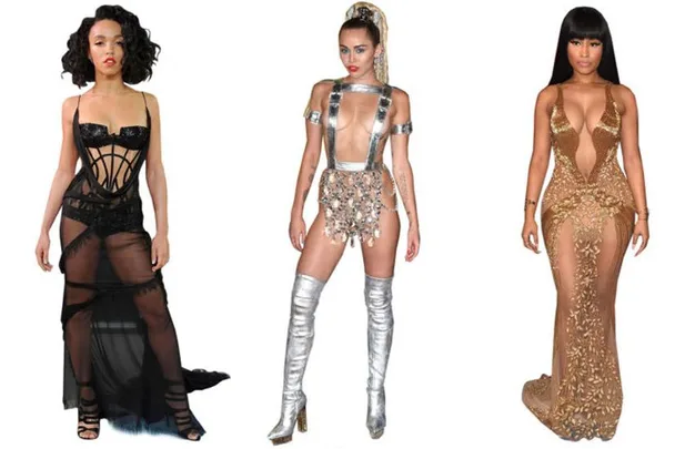 Three women in revealing outfits at an award show, wearing black sheer dress, silver futuristic attire with boots, and gold see-through gown.