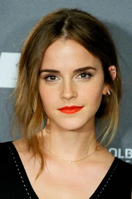 Emma Watson with light brown hair, wearing red lipstick and a black top, at a public event.