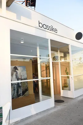 Exterior view of the first Bassike store in the US, featuring large glass windows and minimalist design.