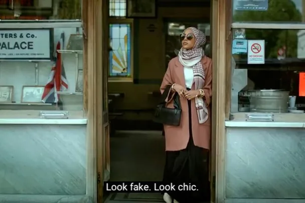 A stylish woman in a hijab and sunglasses stands at a shop entrance, with a sign reading "PALACE" inside. Subtitles: "Look fake. Look chic."