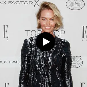 A woman in a black sequined dress smiling on the red carpet at the Elle Style Awards 2015.