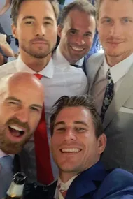 Group of five men in suits taking a selfie, smiling at the Melbourne Cup.