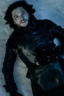 Jon Snow, wounded and lying on snow in dark armor, from "Game of Thrones."