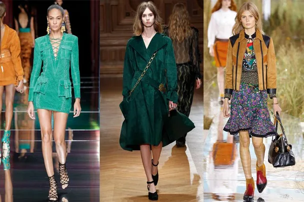 Three models on runway: green lace-up mini dress, green coat with chain belt, and floral skirt with brown jacket.