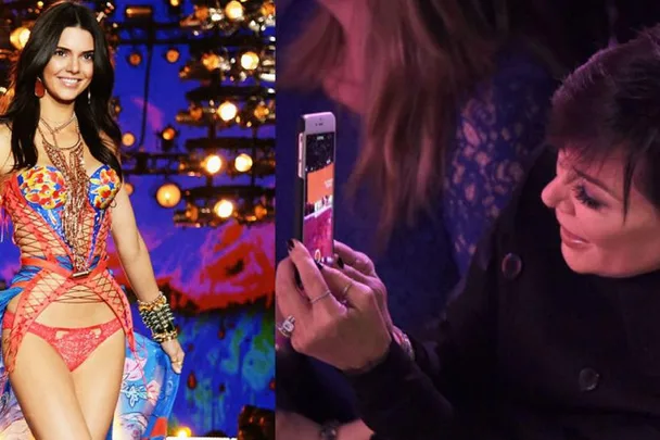 Kendall Jenner walks a runway in colorful lingerie while Kris Jenner, in the audience, films her with a phone.