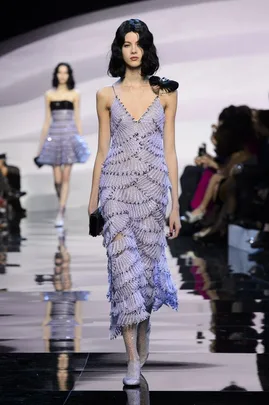 Model walking on runway in a lavender, fringed Giorgio Armani Prive dress during the Haute Couture SS16 show.