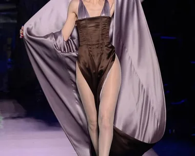 Model in satin mauve gown with dramatic cape, Jean Paul Gaultier Haute Couture SS16 runway.