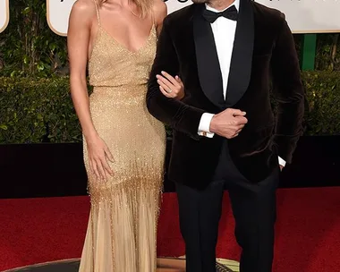 "Rosie Huntington-Whiteley and partner on the red carpet at the Golden Globe Awards."