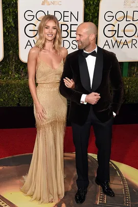 "Rosie Huntington-Whiteley and partner on the red carpet at the Golden Globe Awards."