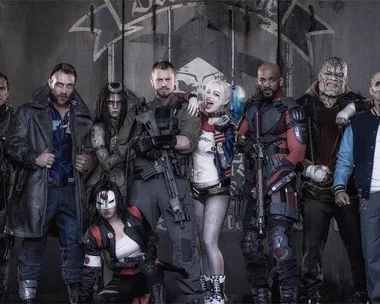 The Suicide Squad characters in costume, including Harley Quinn, Deadshot, Rick Flag, Captain Boomerang, and Katana, posing together.