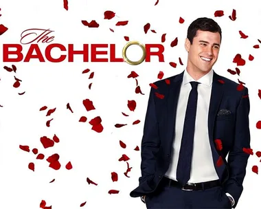 The Bachelor promotional image with a man in a suit surrounded by rose petals.