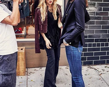 Rachel Zoe speaks with a woman wearing UGG boots while being filmed on a sidewalk.