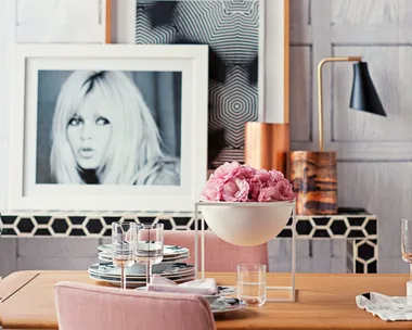 A chic, pastel-hued office space with poster of Brigitte Bardot.