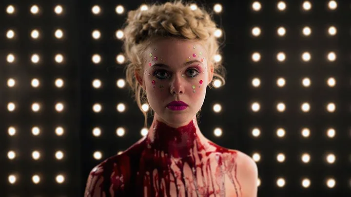 Elle Fanning plays a murderous model alongside Abbey Lee Kershaw, Keanu Reeves, Christina Hendricks, and Jenna Malone in Nicholas Winding Refn's The Neon Demon