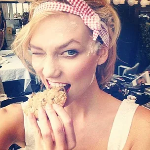 Karlie Kloss eats a cookie