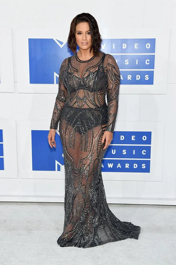 Woman in a sheer, beaded gown on the red carpet at the MTV Video Music Awards.