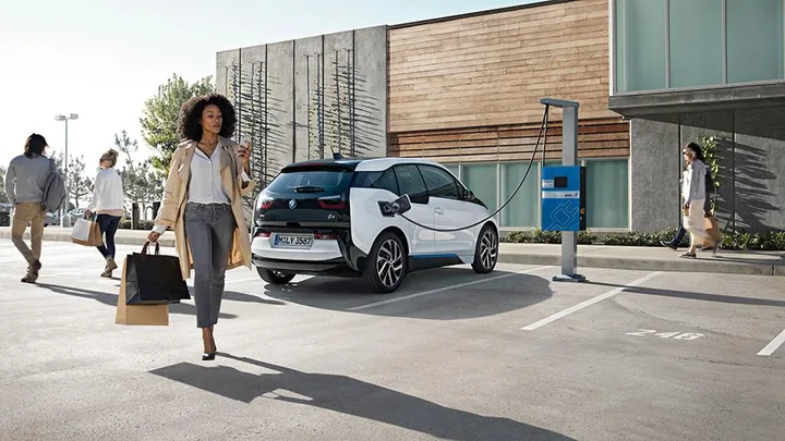 Woman with her electric car.