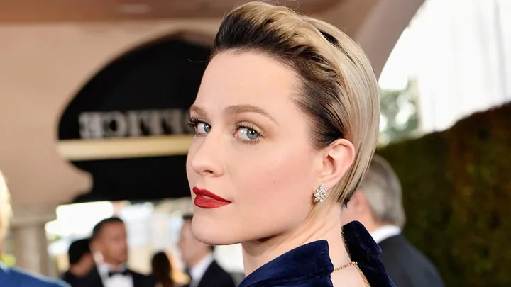 Evan Rachel Wood at the SAG Awards, with short blonde hair and red lipstick, wearing statement earrings and a blue outfit.