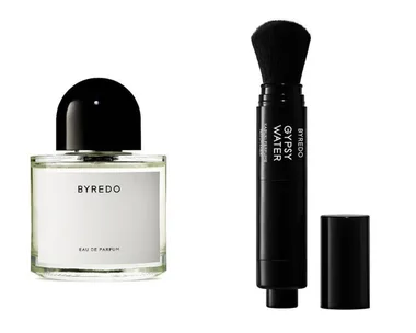 Byredo Eau de Parfum bottle beside a Byredo Gypsy Water Kabuki Perfume brush on a white background.