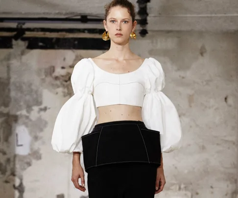 Model on runway wearing white puff-sleeve top and black skirt at Ellery Spring 2018 Paris Fashion Week.