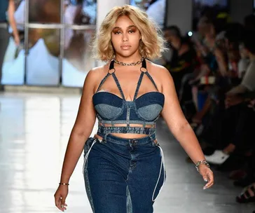 Jordyn Woods walks the runway in a denim outfit during New York Fashion Week at the Chromat show.