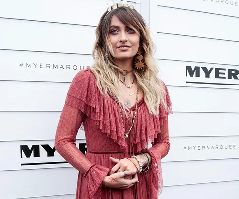 Paris Jackson at the Melbourne Cup's Myer Marquee, wearing a red dress and various accessories.