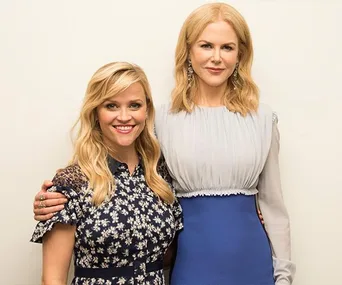 Reese Witherspoon and Nicole Kidman at a promotional event for "Big Little Lies," both smiling and standing side by side.