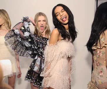 Models in floral and lace dresses pose playfully backstage at Alice McCall's NY Fashion Week debut.