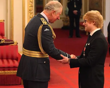 Ed Sheeran receives an honor from Prince Charles in a formal ceremony at Buckingham Palace.