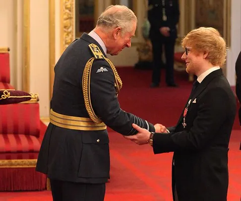 Ed Sheeran receives an honor from Prince Charles in a formal ceremony at Buckingham Palace.