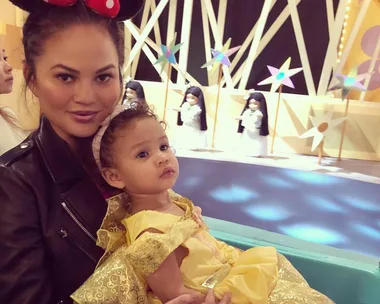 Chrissy Teigen with daughter Luna, dressed as Belle from Beauty and the Beast, at Disneyland.