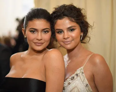 Two women at the Met Gala, one in a black dress and the other in a white gown.