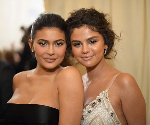 Two women at the Met Gala, one in a black dress and the other in a white gown.