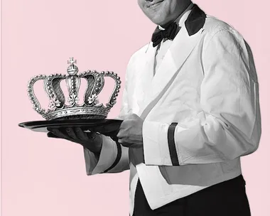 A waiter in formal attire holds a tray with a royal crown on it against a pink background.