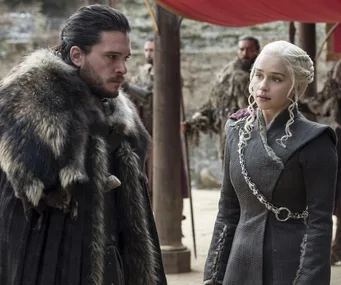 Jon Snow and Daenerys Targaryen discussing in an outdoor camp in "Game of Thrones."