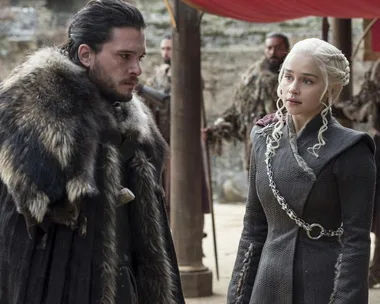 Jon Snow and Daenerys Targaryen discussing in an outdoor camp in "Game of Thrones."