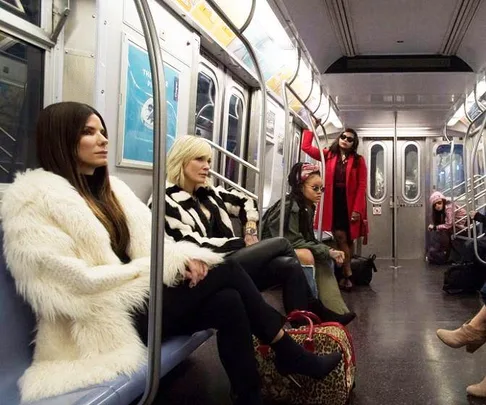 Sandra Bullock, Cate Blanchett, Rihanna, and Mindy Kaling's characters in a subway scene from Ocean's 8.