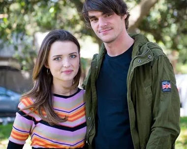 Philippa Northeast and RJ Mitte standing side by side outdoors, both smiling at the camera.