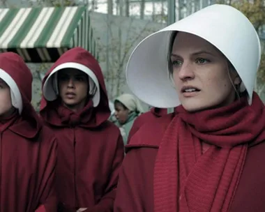 A scene from "The Handmaid's Tale" showing women in red cloaks and white bonnets, including June Osborne played by Elisabeth Moss.