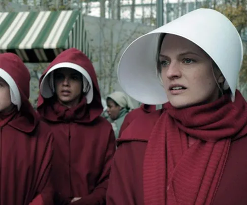 A scene from "The Handmaid's Tale" showing women in red cloaks and white bonnets, including June Osborne played by Elisabeth Moss.