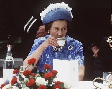 Queen Elizabeth drinking tea.