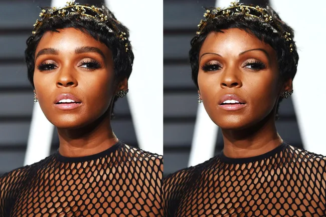 Janelle Monáe wearing a black mesh outfit and gold headpiece, posing at an event with glamorous makeup.